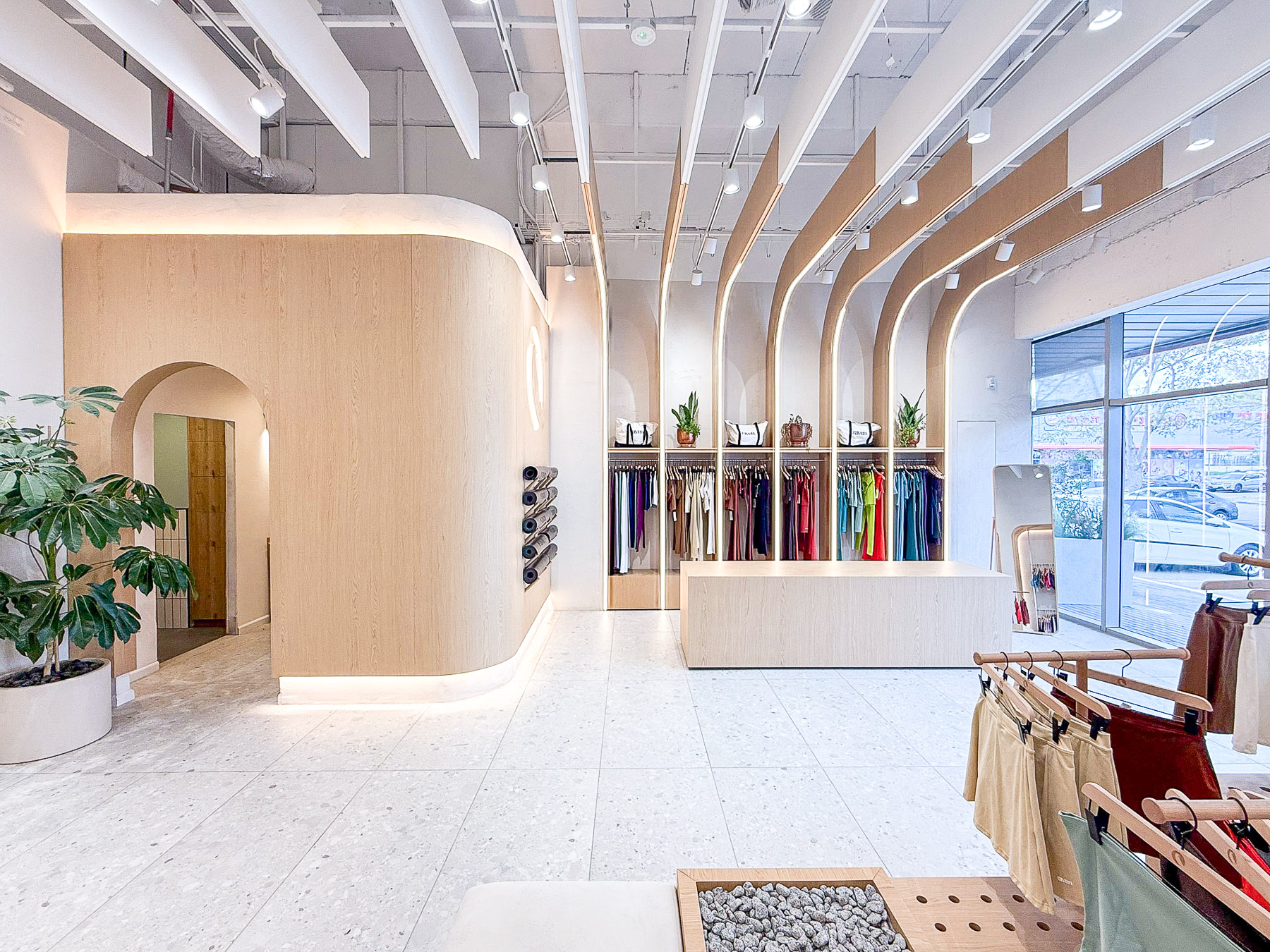 חלל תצוגה מרכזי בחנות בגדי ספורט לנשים בחיפה עם קשתות ותאורה היקפית